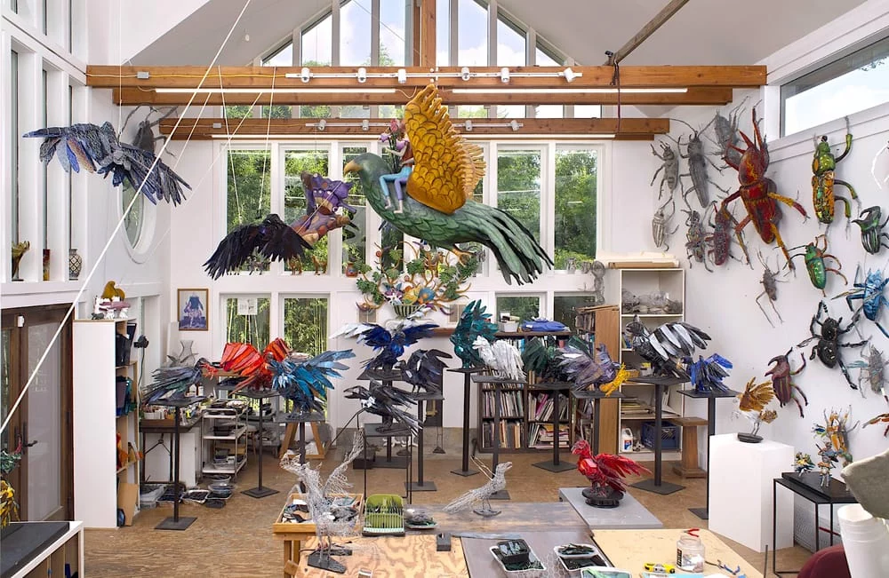Joan Danizger's studio showing glass beatles and birds suspended from the ceiling.