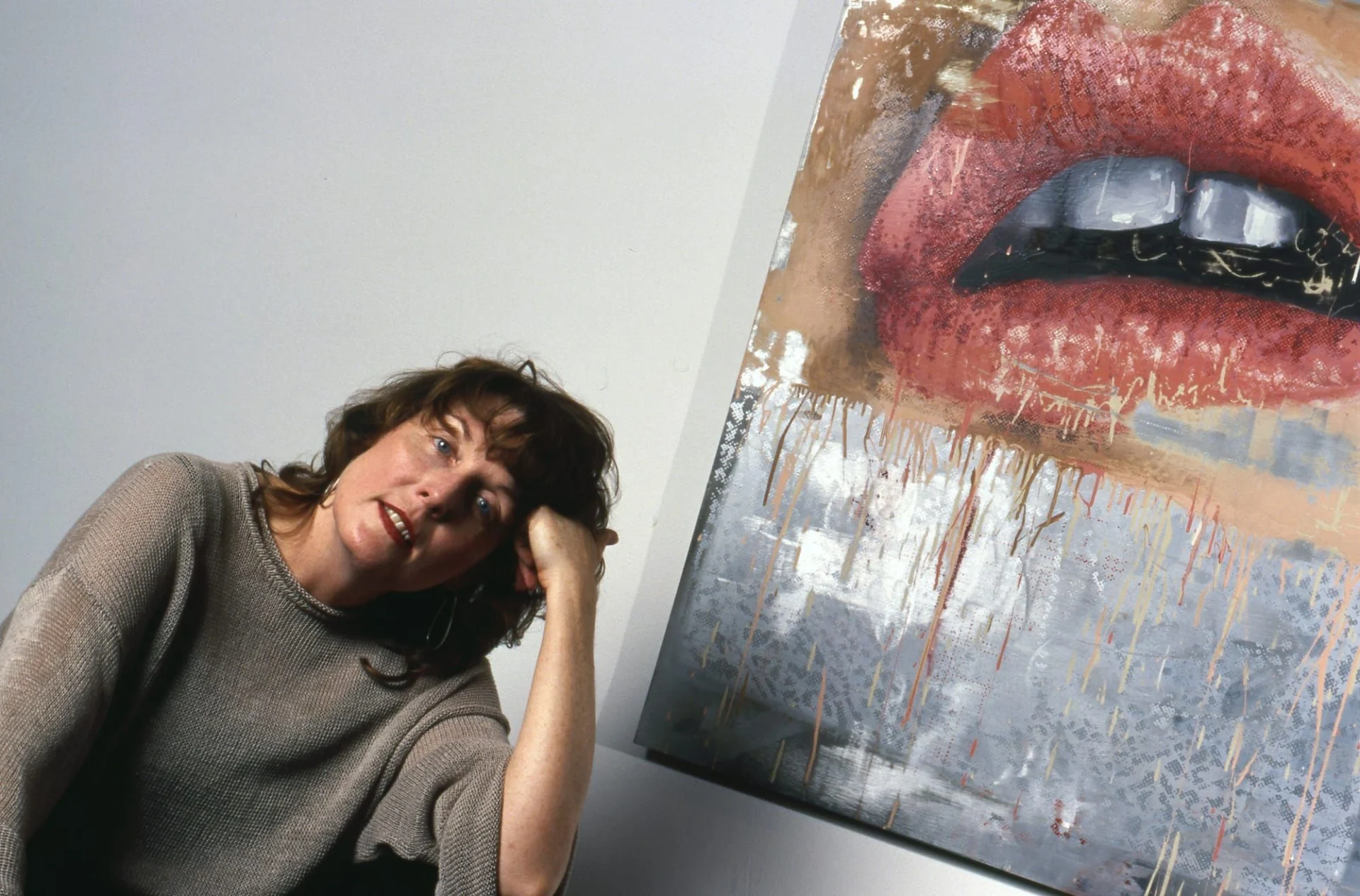 Artist Marilyn Minter poses for a portrait in front of one of her paintings of lips in 1995 in New York City, New York (photo Catherine McGann/Getty Images)